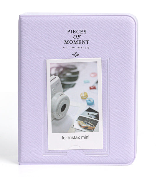 Lavender photo album with a window displaying an instant photo of a camera and photos on a white background