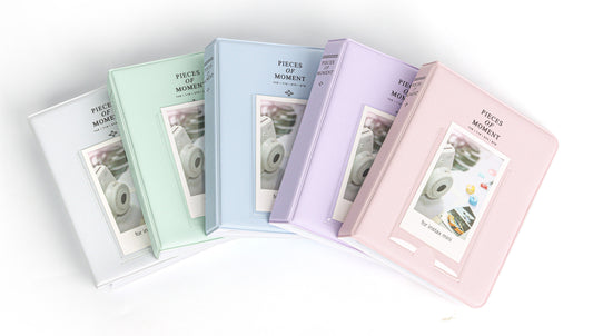 Set of pastel-colored photo albums on a white background